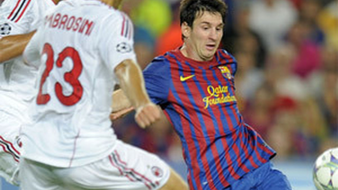 Messi trata de driblar la defensa del Milán