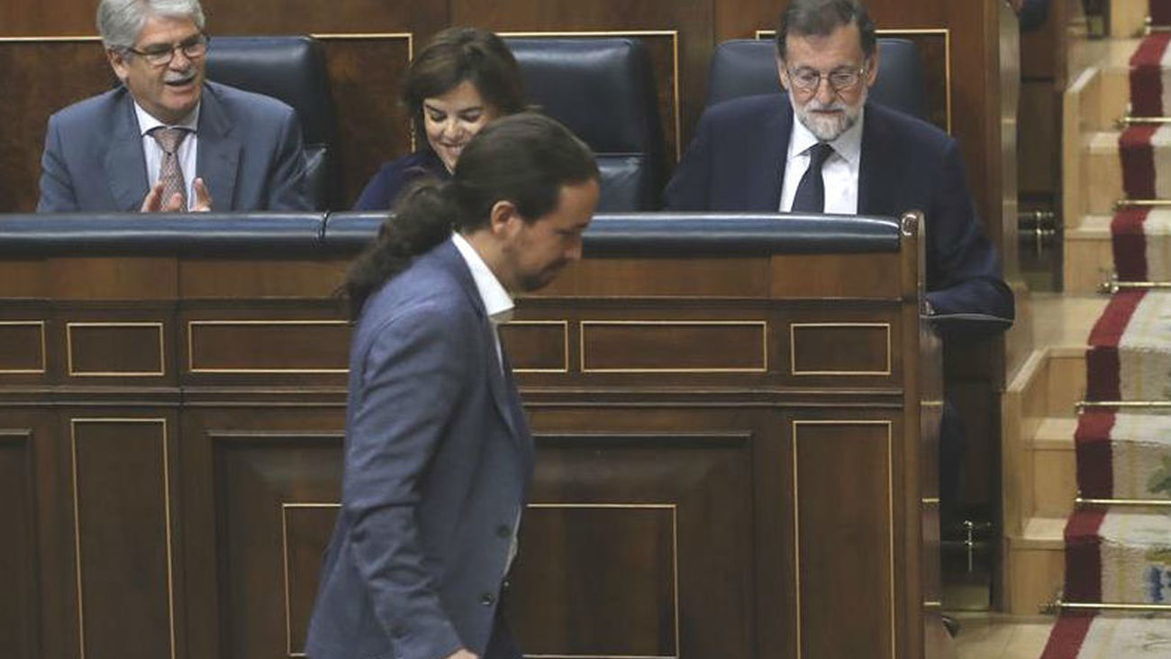 El líder de Podemos, Pablo Iglesias, pasa delante del presidente del Gobierno, Mariano Rajoy