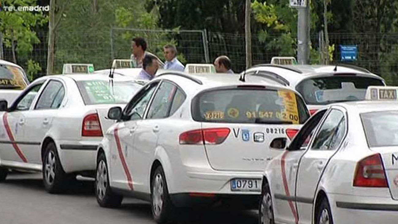 Taxistas esperan usuarios en una parada