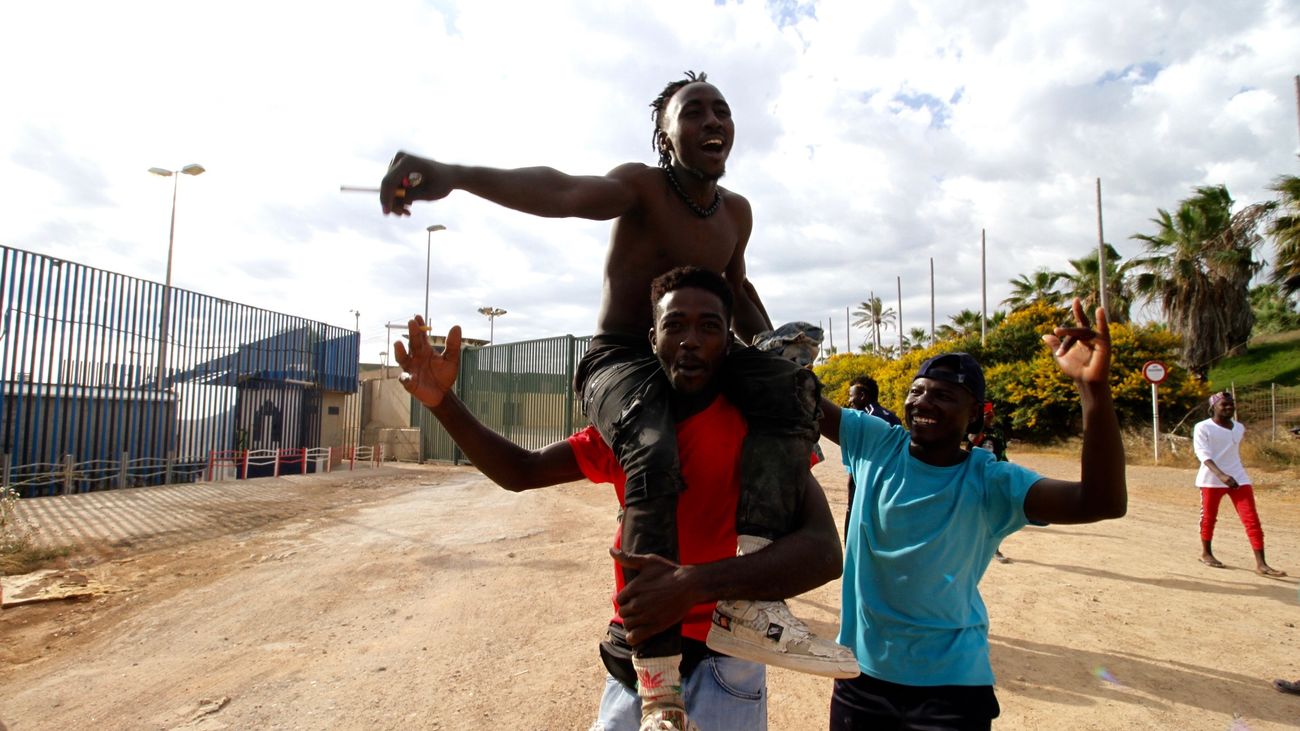 Varios migrantes se dirigen al Centro Temporal de Inmigrantes (CETI), mientras celebran el salto de la valla de Melilla, a 24 de junio de 2022, en Melilla