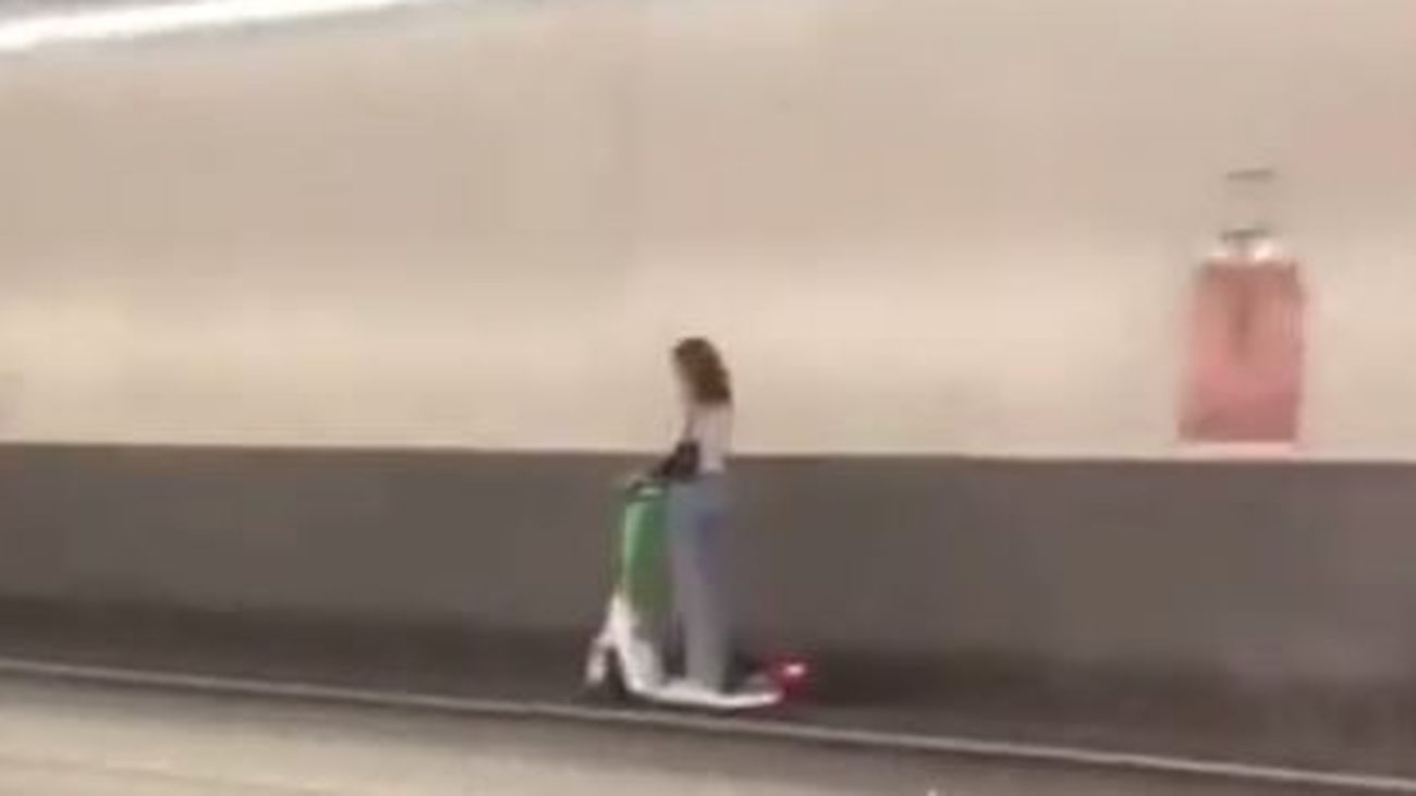 Una joven circula en un patinete por el túnel de la M-30
