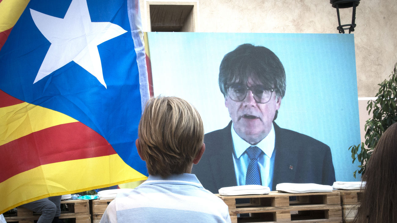 Un niño observa la intervención telemática de Carles Puigdemont