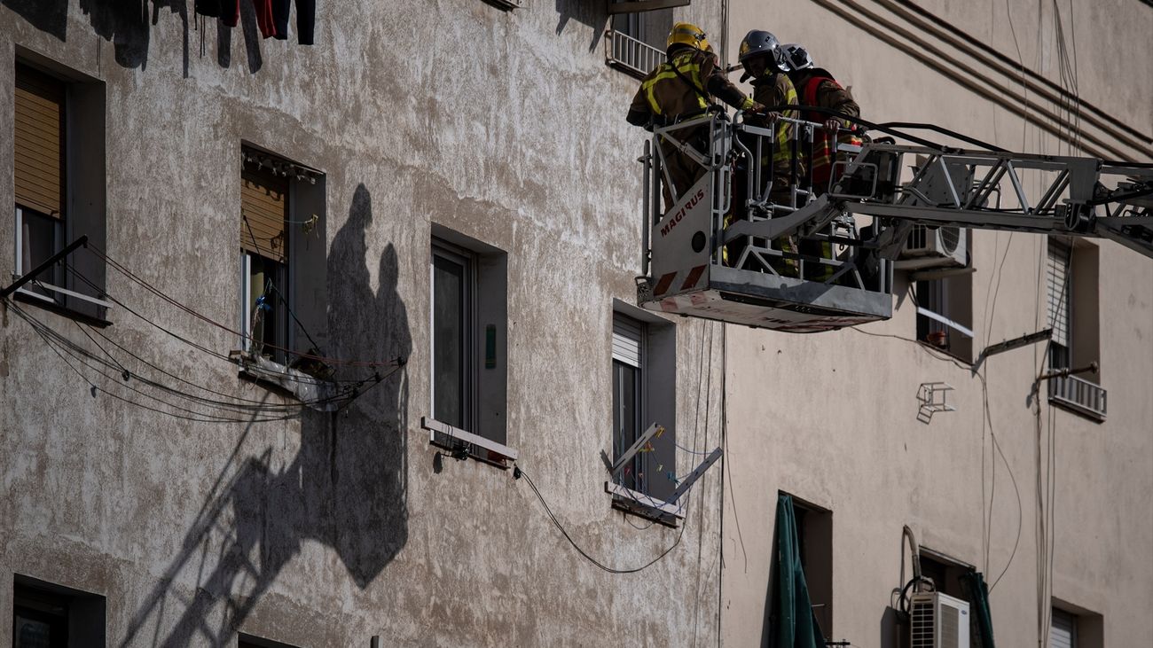 Varios bomberos trabajan en el edificio derrumbado en Badalona