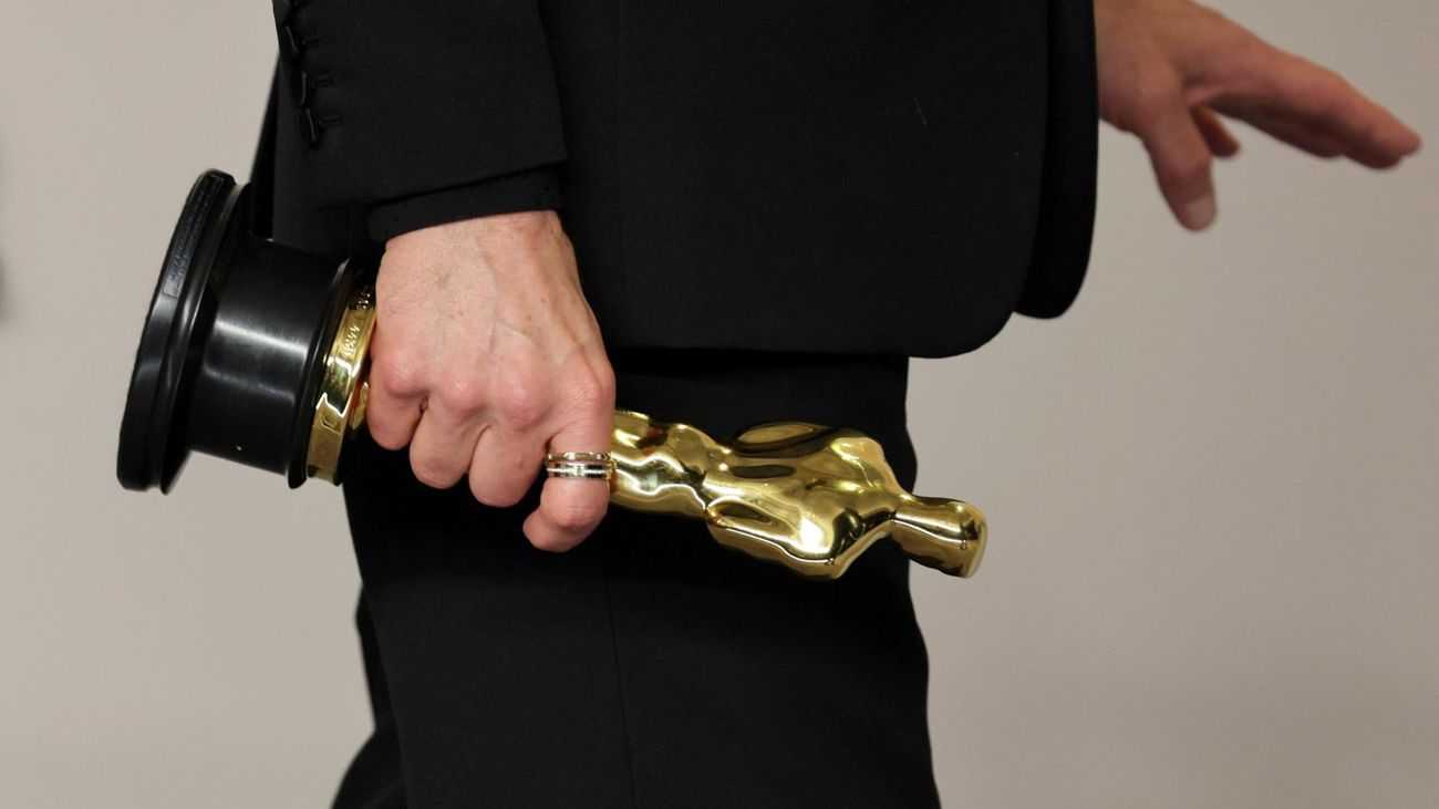 Robert Downey Jr. lleva en la mano su Oscar por Oppenheimer