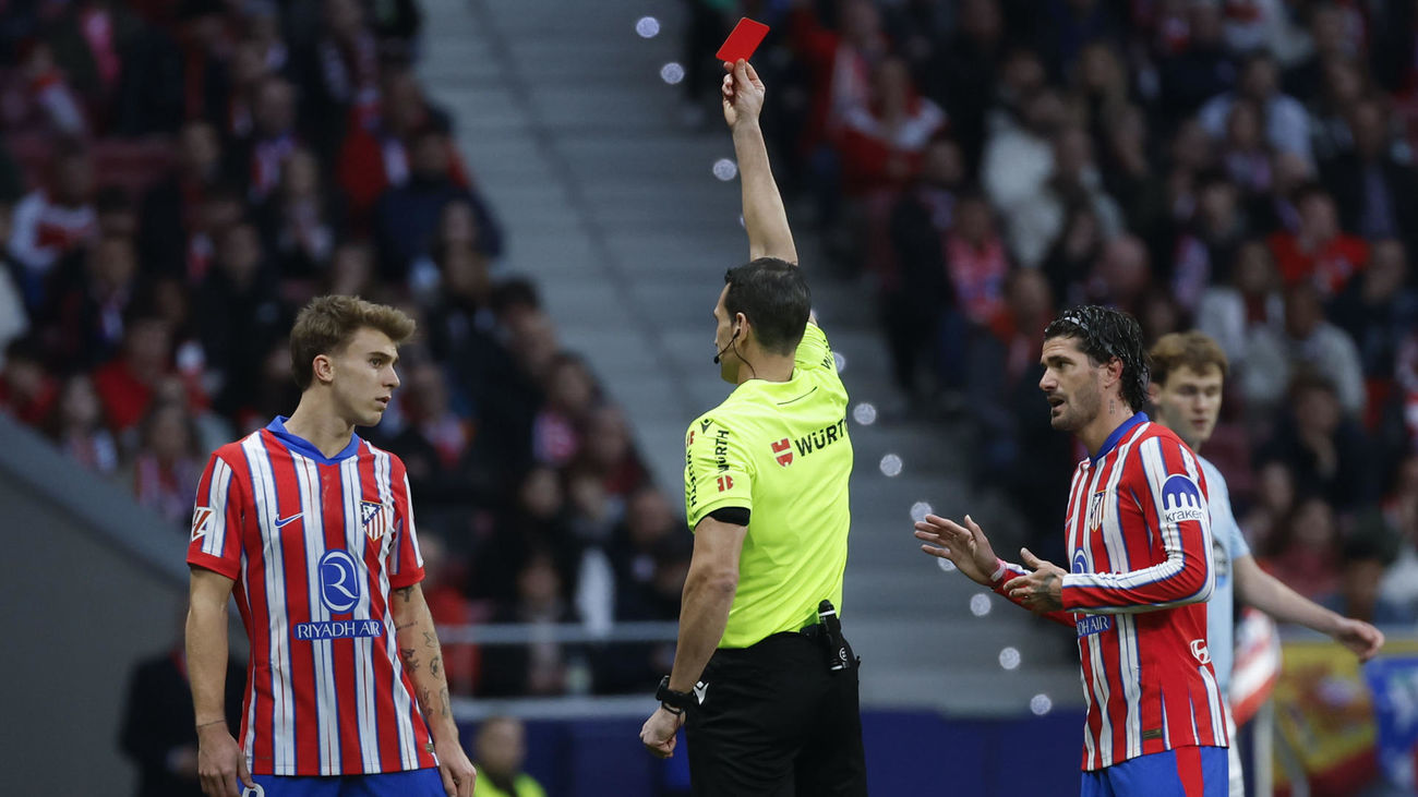 El árbitro Juan Martínez Munuera muestra la tarjeta roja al centrocampista del Atlético de Madrid Pablo Barrios