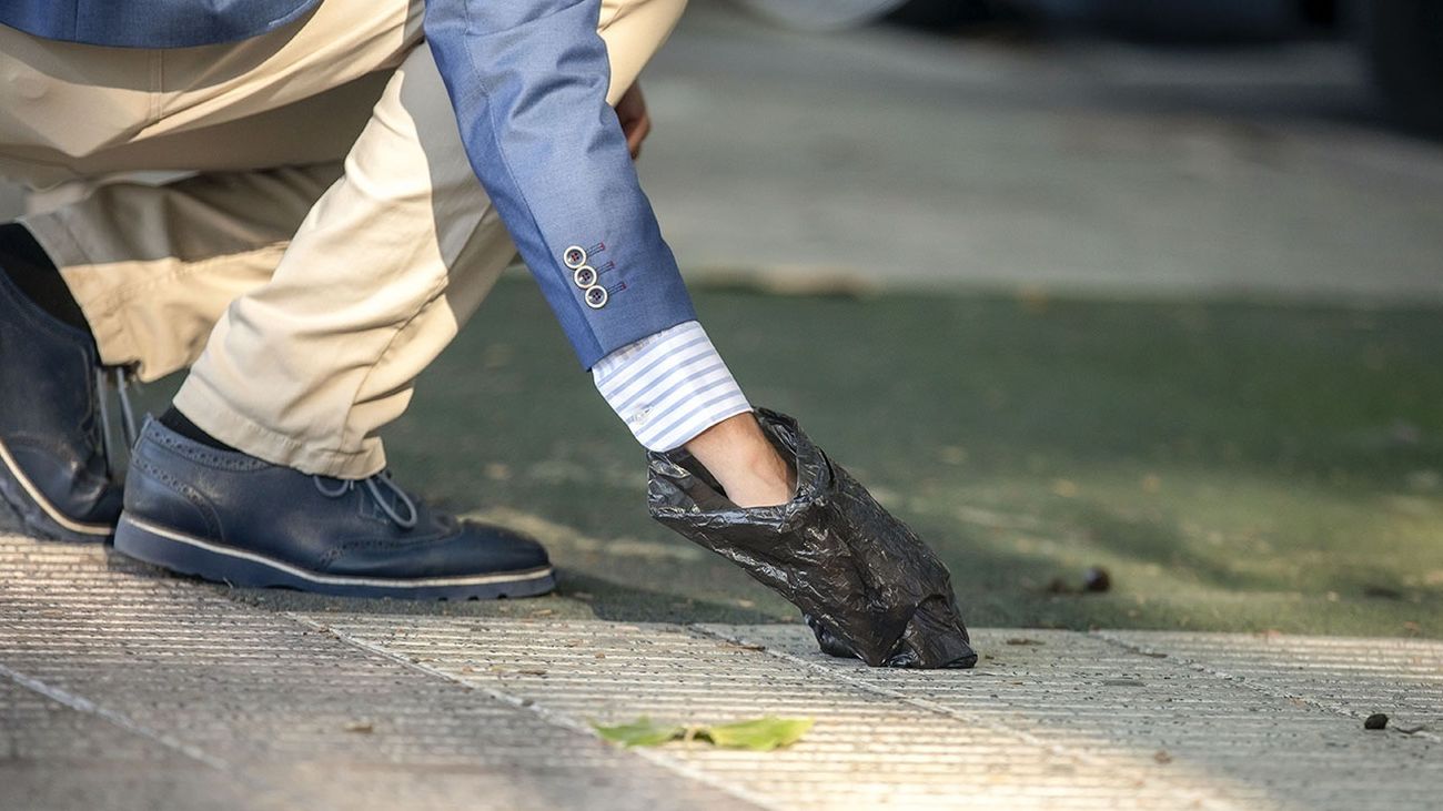 Una persona recoge las deposiciones de su perro en la vía pública