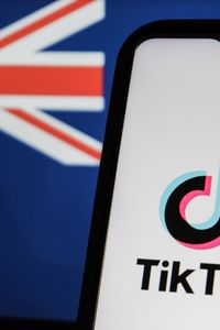 El logotipo de TikTok en la pantalla de un teléfono con la bandera australiana de fondo