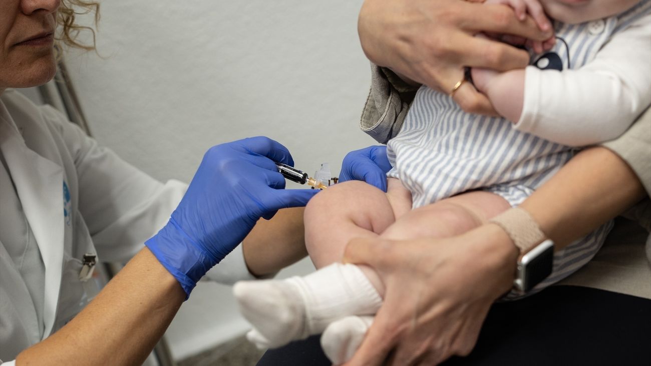Una sanitaria vacuna a un bebé en un centro de salud de Madrid