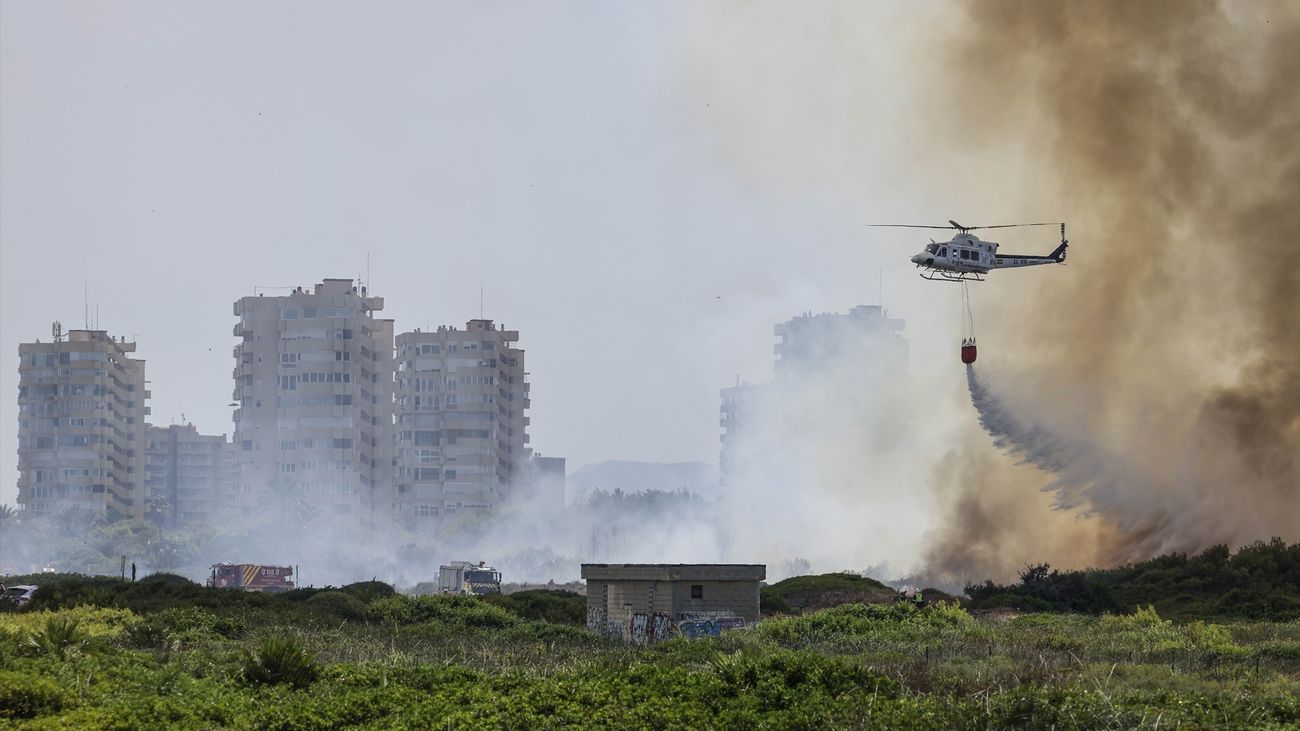 Helicóptero durante las labores de extinción de un incendio forestal  en la Gola de Pujol, El Saler