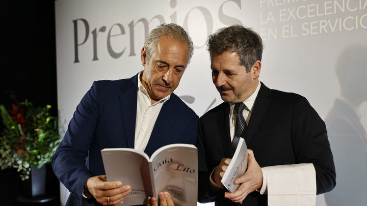 El presidente de Hostelería Madrid, José Antonio Aparicio (a la izquierda), y el consejero de Cultura, Turismo y Deporte, Mariano de Paco (a la derecha), ojeando la guía de los Premios LITO 2025 en un momento de la gala. / HOSTELERÍA MADRID